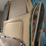 Cream Upholstered Bed with Decorative Accent Trim, Brand Emblem & Gold Stainless Steel Feet